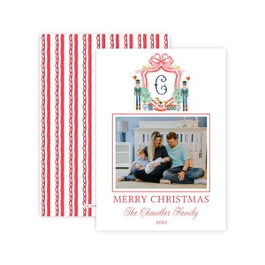 May include: A rectangular Christmas card featuring a red and white striped pattern on the back. The front displays a watercolor crest with a letter C, nutcrackers, and a photo of a family. Text reads MERRY CHRISTMAS The Chandler Family 2023.