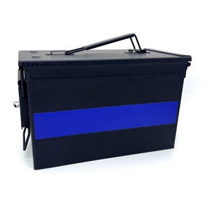 May include: Black metal ammo can with a blue stripe across the front. The can has a hinged lid and a carrying handle.