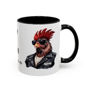 May include: A white ceramic mug with a black interior and handle. The exterior features a graphic of a rooster wearing black sunglasses and a black leather jacket with the name Randy printed on the chest. Text on the side reads Life is a Mess Life.