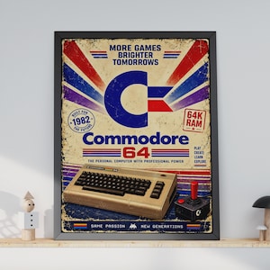 Op de afbeelding: Een ingelijste poster met een Commodore 64 computer en joystick. Het ontwerp bevat de tekst MORE GAMES BRIGHTER TOMORROWS, BUILT FOR 1982 THE FUTURE, 64K RAM, Commodore 64, PLAY CREATE LEARN EXPLORE en SAME PASSION NEW GENERATIONS.