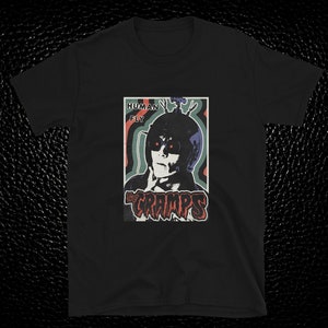 May include: Black t-shirt with a vintage-style graphic of a person wearing a helmet with the text "Human Fly" and the band name "The Cramps" in red and black lettering.