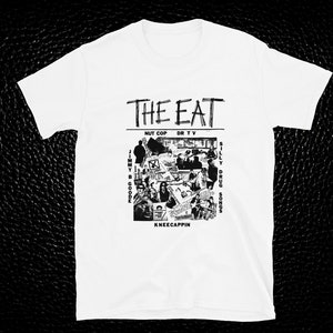 May include: White t-shirt featuring a black and white graphic print of a collage of images and text. The text reads "THE EAT", "NUT COP", "DR TV", "JIMMY B GOODE", "SILLY DRUG SONGS", and "KNEECAPPIN".