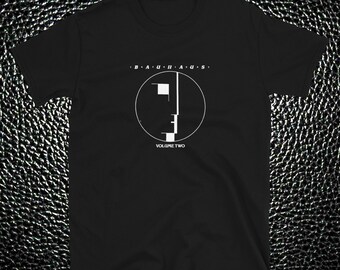 May include: Black t-shirt with a white graphic of the Bauhaus band logo and the text "VOLUME TWO".