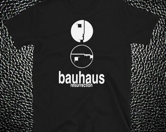 May include: Black t-shirt with a white Bauhaus logo, featuring two circles with abstract designs and the text "bauhaus resurrection".