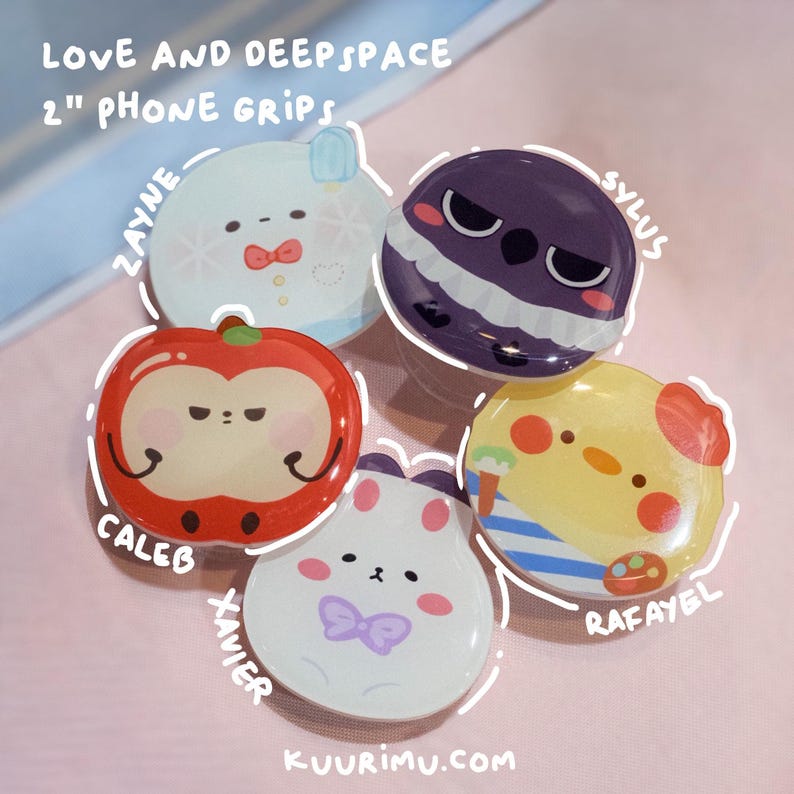 May include: Five circular 2-inch phone grips featuring Love and Deepspace character illustrations. The designs include a white Zayne character, a purple Sylus character, a red Caleb apple character, a yellow Rafayel character, and a white Xavier rabbit character.
