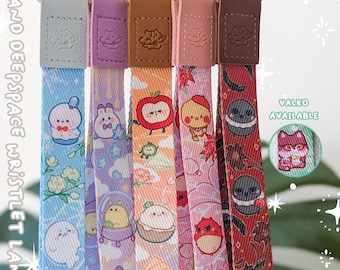 May include: Five fabric wristlet lanyards with gold-tone metal lobster clasps and leather-like tabs. Each strap features colorful cartoon character prints including space themes, fruits, and animals. Text on the image reads LOVE AND DEEPSPACE WRISTLET LANYARD, KUURIMU.COM, and VALKO AVAILABLE.
