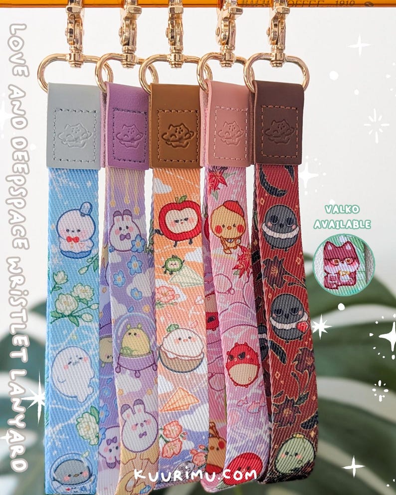 May include: Five fabric wristlet lanyards with gold-tone metal lobster clasps and leather-like tabs. Each strap features colorful cartoon character prints including space themes, fruits, and animals. Text on the image reads LOVE AND DEEPSPACE WRISTLET LANYARD, KUURIMU.COM, and VALKO AVAILABLE.