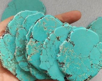 May include: A collection of turquoise stones, each with a unique pattern and texture. The stones are arranged in a flower-like shape, with the largest stone in the center.