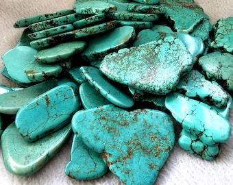 May include: A collection of turquoise stones, each with a unique shape and pattern of veins. The stones are a vibrant blue-green color and have a smooth, polished finish.