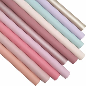 May include: A set of ten faux leather sheets in various pastel colors, including pink, peach, lavender, and light blue. The sheets have a textured surface and are perfect for crafting projects.