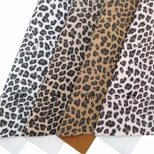 May include: Four different leopard print fabrics in white, brown, tan, and pink. The fabrics are labeled with numbers 2, 5, 6, and 7.