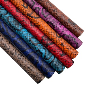 May include: A set of six faux leather sheets with a snake skin pattern in various colours, including brown, orange, red, blue, and purple.