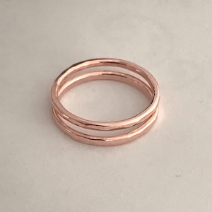 May include: A rose gold double band ring with a hammered finish.