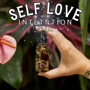 May include: A glass bottle filled with a clear liquid and various dried flowers and herbs. The bottle has a dropper and is labeled "Self Love Intention Oil".