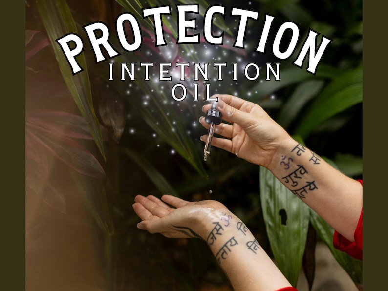 May include: A hand holds a dropper bottle labeled "Protection Intention Oil" over another hand with a tattoo in Sanskrit. The background is a blurred image of green foliage.