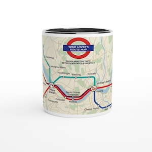 May include: White ceramic mug with a black interior featuring a map design. The map is a wine lover's route map with text including "Wine Lover's Route Map" and "Please mind the taste between vintages & varietals."