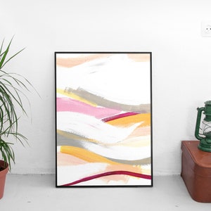 May include: Abstract painting in a black frame with a white background and colorful brushstrokes in shades of pink, yellow, orange, and gray.
