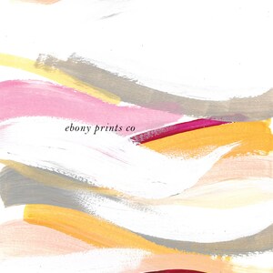 May include: Abstract art print with a white background and colorful brushstrokes in shades of pink, yellow, orange, and gray. The text "ebony prints co" is centered in the middle of the print.