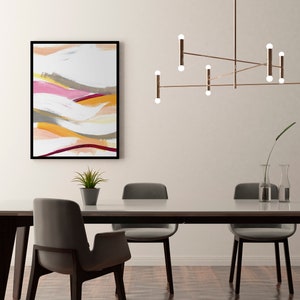 May include: A modern dining room with a white wall, a wooden table with six chairs, a contemporary light fixture with multiple bulbs, and a framed abstract painting with colorful brushstrokes.