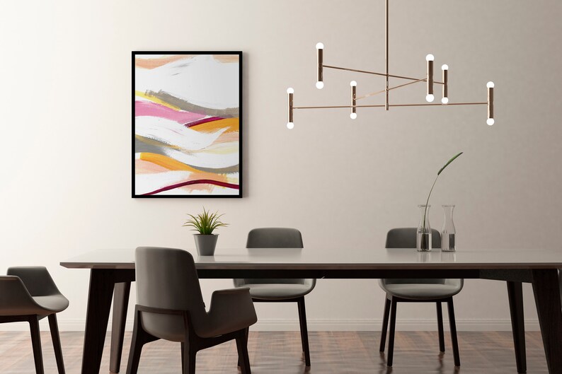 May include: A modern dining room with a white wall, a wooden table with six chairs, a contemporary light fixture with multiple bulbs, and a framed abstract painting with colorful brushstrokes.