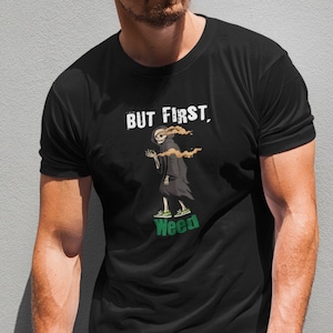 May include: Black t-shirt with a graphic of a skeleton smoking a joint and the text "BUT FIRST, Weed".