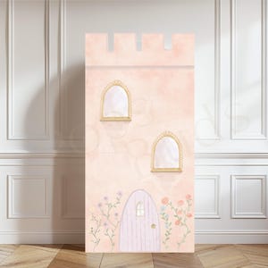 May include: A pink castle backdrop featuring a purple door, two gold windows, and floral vines. The backdrop is ideal for a princess-themed party or photo shoot.