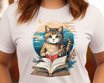May include: White t-shirt with a graphic of a cat reading a book. The cat is brown, black, and white with blue eyes. The book is open and has a red cover. The background is a blue and white ocean scene with a crescent moon.