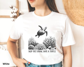 May include: White t-shirt with a black and white illustration of a sea turtle swimming over coral. The text "SKIP THE STRAW, SAVE A TURTLE" is printed below the illustration.