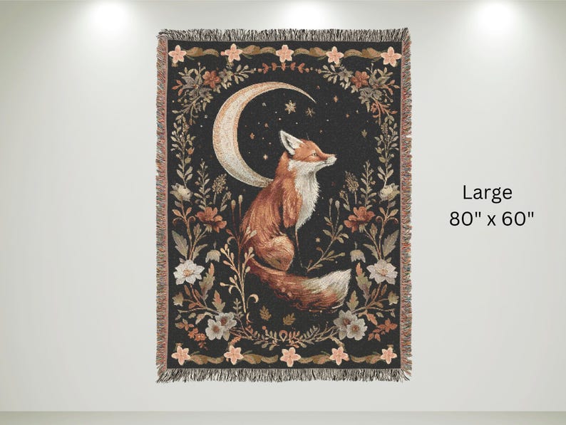 May include: A woven tapestry featuring a fox sitting under a crescent moon with stars. The tapestry has a black background with floral designs in shades of pink, orange, and white. The tapestry is 80 inches by 60 inches.