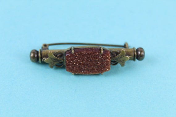 Victorian sunstone nanny brooch with hidden needle