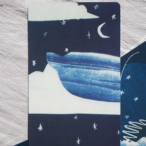 May include: A tarot card featuring a night sky scene with a crescent moon, stars, and a stylized mountain range. The card is predominantly navy blue and white, with the words "The Chariot VII" at the bottom.