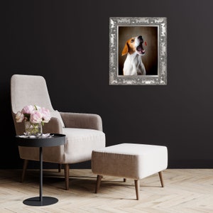 May include: A framed photograph of a brown and white dog with its mouth open, looking up. The dog is in a silver frame with ornate details. The frame is hanging on a black wall.