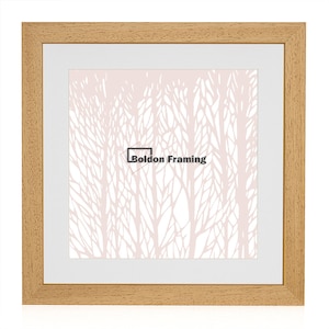 May include: A square, natural wood picture frame with a white mount and a light pink background with a white tree design. The text "Boldon Framing" is printed in black in the centre of the image.