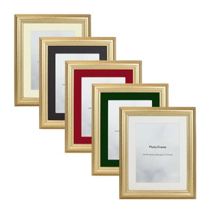 May include: A selection of gold-coloured photo frames with different coloured mounts: cream, black, red, and green. The frames have a textured finish and are arranged diagonally. The bottom frame has the text "Photo Frame" and "Can Be Used Landscape or Portrait".