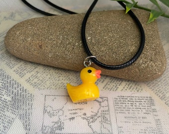 Yellow rubber duck necklace- plastic charm on an 18” black wax cord necklace with 2” extension chain, hypoallergenic