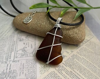 Brown sea glass necklace- Wire wrapped beach glass on 18 inch black wax cord necklace with 2 inch extension chain, hypoallergenic