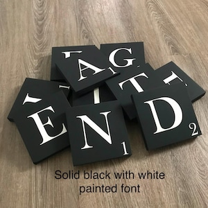 Black scrabble wall tiles, scrabble letters, crossword puzzle, blended family gallery wall, different colors and sizes