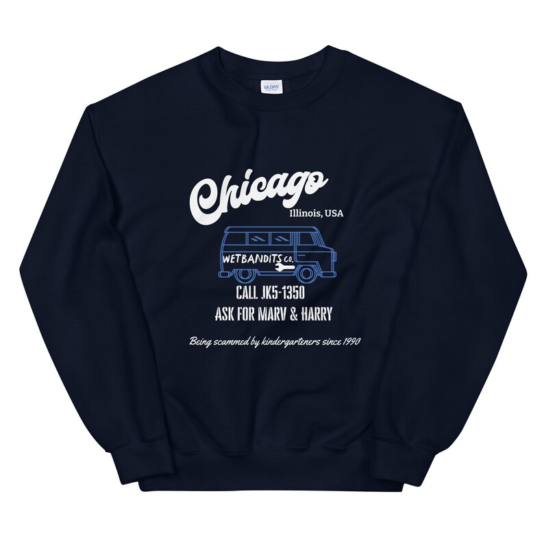 May include: Navy blue sweatshirt with a white graphic that says "Chicago" and "Illinois, USA". Below the text is a blue illustration of a van with the text "WETBANDITS CO." and "CALL JK5-1350 ASK FOR MARV & HARRY". The text "Being scammed by kindergarteners since 1990" is also included.