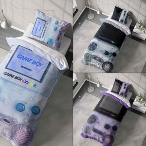 May include: Bedding set with a Game Boy Color theme. The duvet cover and pillowcase display a large graphic of the retro console in blue, purple, and black. The text "GAME BOY COLOR" is visible on the bedding, evoking a nostalgic feel.