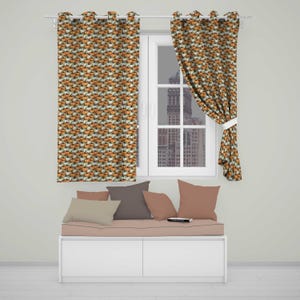 May include: Two window curtains featuring a repeating pattern of orange and white pumpkins on a dark background. The curtains are hung on a white rod over a window. Below the window is a bench with several solid-coloured throw pillows in shades of brown.