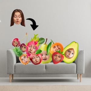 May include: A surreal image shows a woman's face morphing into an assortment of fruits, such as a cherry, dragon fruit, pear, orange, strawberry, pineapple, apple, and avocado. Each fruit has a face. The fruits are arranged on a grey sofa.