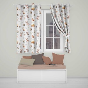 May include: White curtains featuring a repeating pattern of brown and orange woodland animals including deer, foxes, owls, raccoons, and bears, paired with a bench featuring a light pink cushion and four throw pillows in shades of brown and tan.