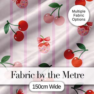 May include: Fabric featuring a repeating pattern of cherries and pink stripes. Some cherries are dipped in pink frosting with sprinkles and a red bow. The fabric is 150cm wide. The text "Fabric by the Metre" is displayed.