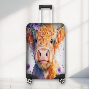 May include: A suitcase with a Highland cow design. The cow has orange fur, a pink nose, and purple flowers. The background is white with purple paint splatters. The suitcase has a retractable handle and wheels.