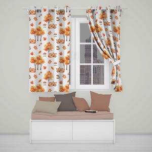 May include: Two white curtains featuring a repeating pattern of orange foxes, yellow and orange autumn trees, red mushrooms, and scattered leaves. The curtains are hung on a rod over a window, with a bench below featuring four solid-coloured pillows.