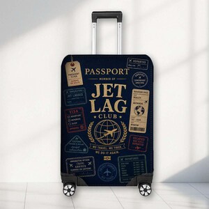May include: A dark blue suitcase cover featuring a travel-themed design with the text Passport Member of Jet Lag Club, We Travel, We Tired, We Do It Again, and various vintage-style passport stamps, boarding passes, and aeroplane icons in gold and white.