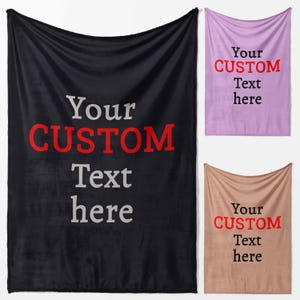 May include: Three custom blankets in black, lavender, and tan. Each blanket features the text "Your CUSTOM Text here" in a contrasting colour. The black blanket has white and red text, the lavender has black and red, and the tan has black and red.