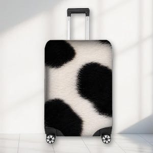 May include: A rectangular upright suitcase featuring a black and white cow print pattern. The luggage has a retractable silver metal handle at the top and four black swivel wheels at the base. The exterior surface displays a textured fur-like appearance.