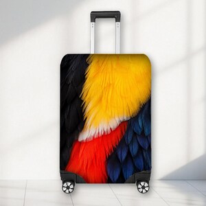 May include: A rolling suitcase featuring a vibrant, high-resolution print of bird feathers. The design displays a striking colour palette of deep black, bright yellow, white, vivid red, and dark blue, covering the entire front surface of the luggage.