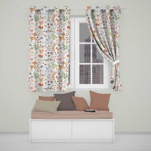 May include: Two white curtains featuring a repeating watercolour pattern of orange foxes, brown deer, grey rabbits, butterflies, green foliage, and pink flowers. The curtains hang on a white rod over a window above a bench with four solid-coloured pillows.